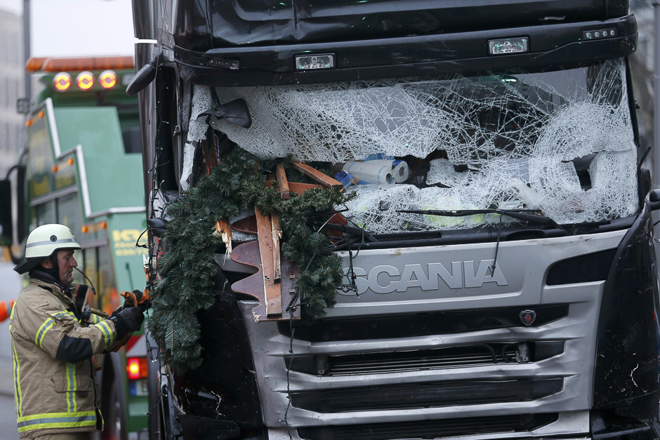 A fire fighter stands beside the truck, which ploughed last night into a crowded Christmas market in the German capital Berlin, Germany. PHOTO: REUTERS