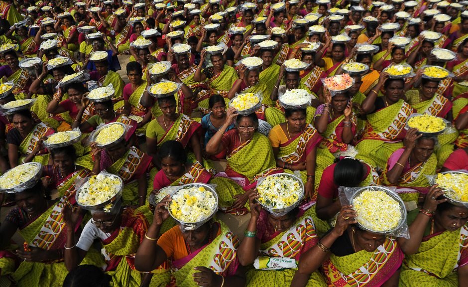 Indian women carry plates of flower for an offering during a ceremony for the victims of the 2004 tsunami at Marina Beach in Chennai on December 26, 2016. The earthquake and tsunami that struck the Indian Ocean on December 26, 2004 killed over 230,000 people and devastated coastal communities, including the shorelines of the southern Indian states of Tamil Nadu, Andhra Pradesh, and Kerala. PHOTO: AFP