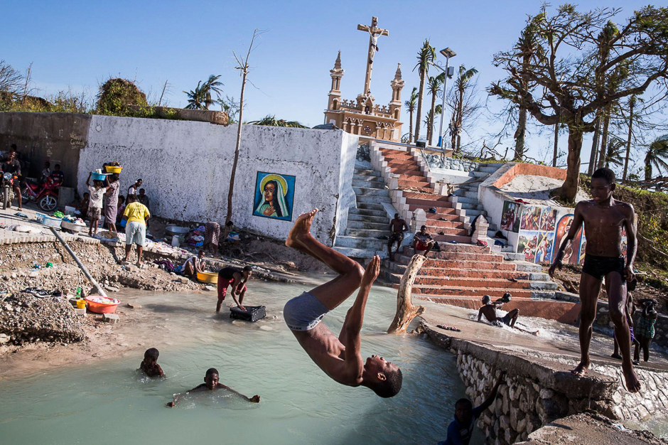 Kids swim in a river where a bridge collapsed in Port Salut, Haiti. The city suffered serious damage from Hurricane Matthew, with many homes completely destroyed. PHOTO: ANDREW MCCONNELL/NATIONAL GEOGRAPHIC