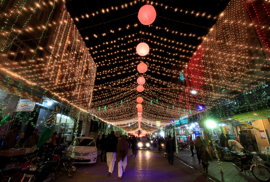 People walk along a decorated street in Rawalpindi, Pakistan. PHOTO: REUTERS