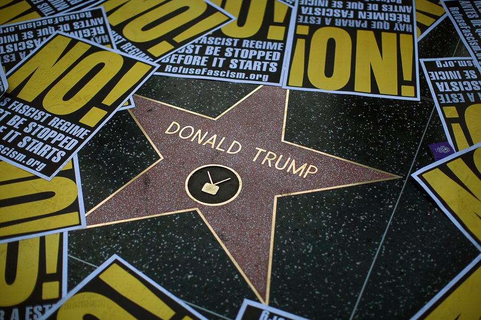The Hollywood Walk of Fame star for Donald Trump is framed in protest posters during a demonstration in reaction to a Twitter post by US President-elect Trump referring to expansion of the United States nuclear arsenal on December 25 in Los Angeles, California. PHOTO: AFP