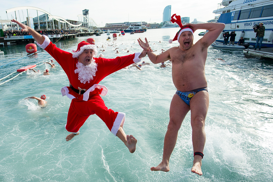 Participants sporting Santa Claus regalia jump into the water during the 107th edition of the Copa Nadal (Christmas Cup) in Barcelona's Port Vell. PHOTO: AFP