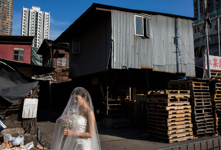 A women poses for wedding photos at the wholesale fruit markets in the Yau Ma Tei district of Hong Kong. PHOTO: AFP