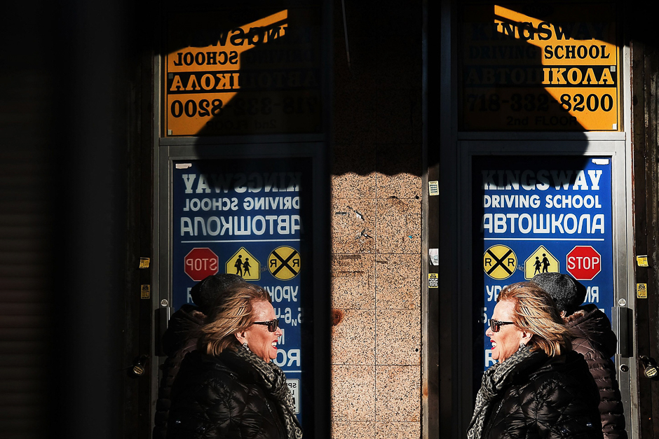 People shop along a street in Brighton Beach, one of the largest Russian speaking enclaves in the Western Hemisphere, in New York City. PHOTO: AFP