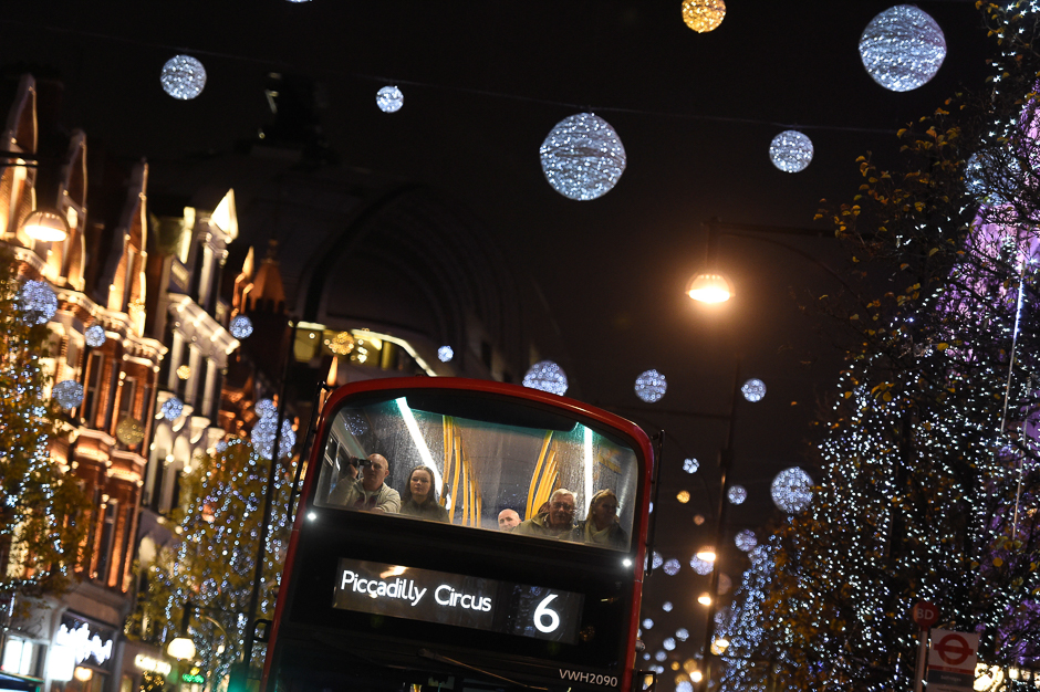 People are seen on a London bus travelling on Oxford Street past Christmas lights in London, Britain. PHOTO: REUTERS