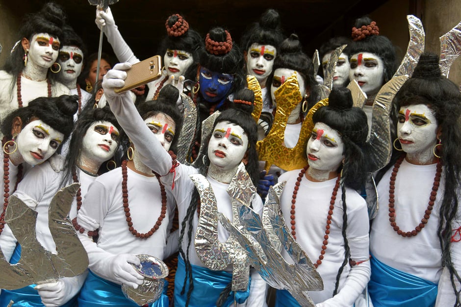 Indian schoolchildren dressed as Hindu God Lord Shiva pose for a 'selfie' ahead of performing a routine during an annual school function in Amritsar. PHOTO: AFP