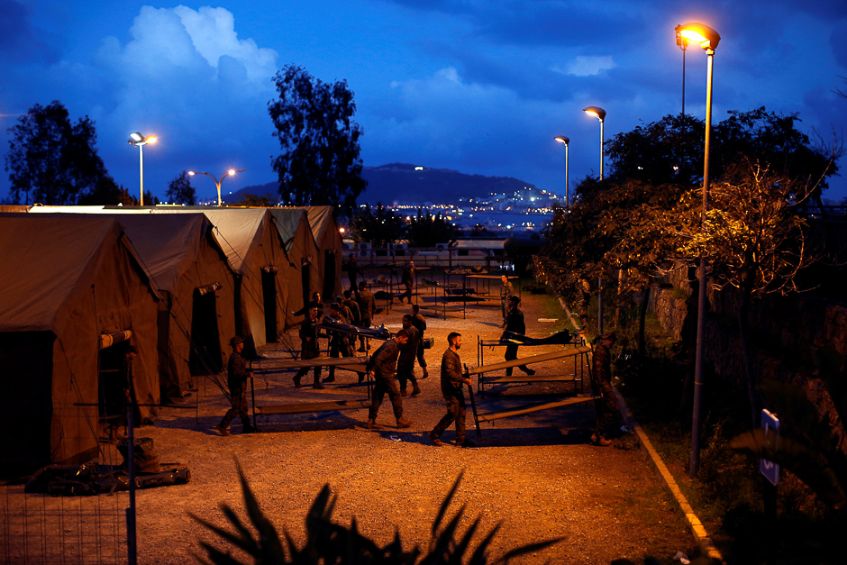 Spanish soldiers assemble support tents after African migrants crossed the border fence between Morocco and Spain's north African enclave of Ceuta outside CETI, the short-stay immigrant centre in Ceuta, Spain. PHOTO: REUTERS