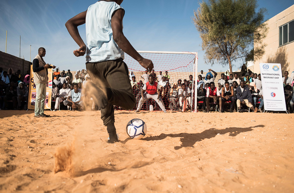 Migrants play football with Libyan guards at the Tariq Al-Matar detention centre on the outskirts of the Libyan capital, Tripoli, on December. PHOTO: AFP