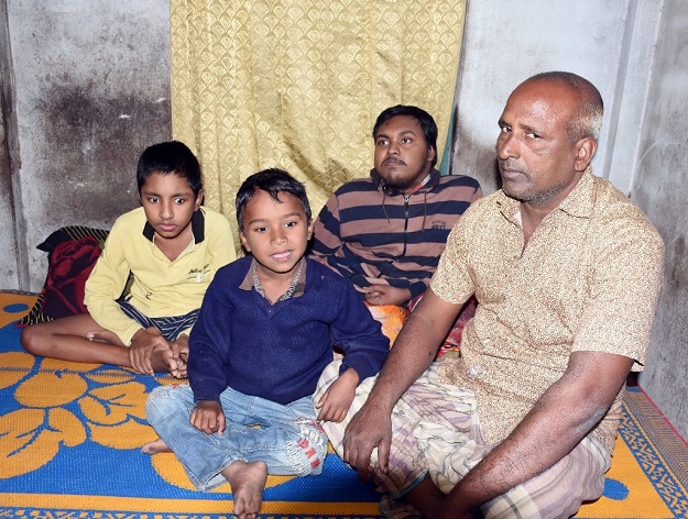 Tofazzal Hossain with his son and grandson. PHOTO: AFP