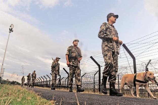 Border Security Force personnel patrol along the Indo-Bangladesh border. PHOTO: AFP