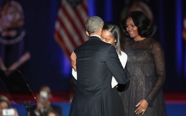 President Barack Obama greets his wife Michelle and daughter Malia following his farewell speech to the nation on January 10, 2017 in Chicago, Illinois. PHOTO: AFP