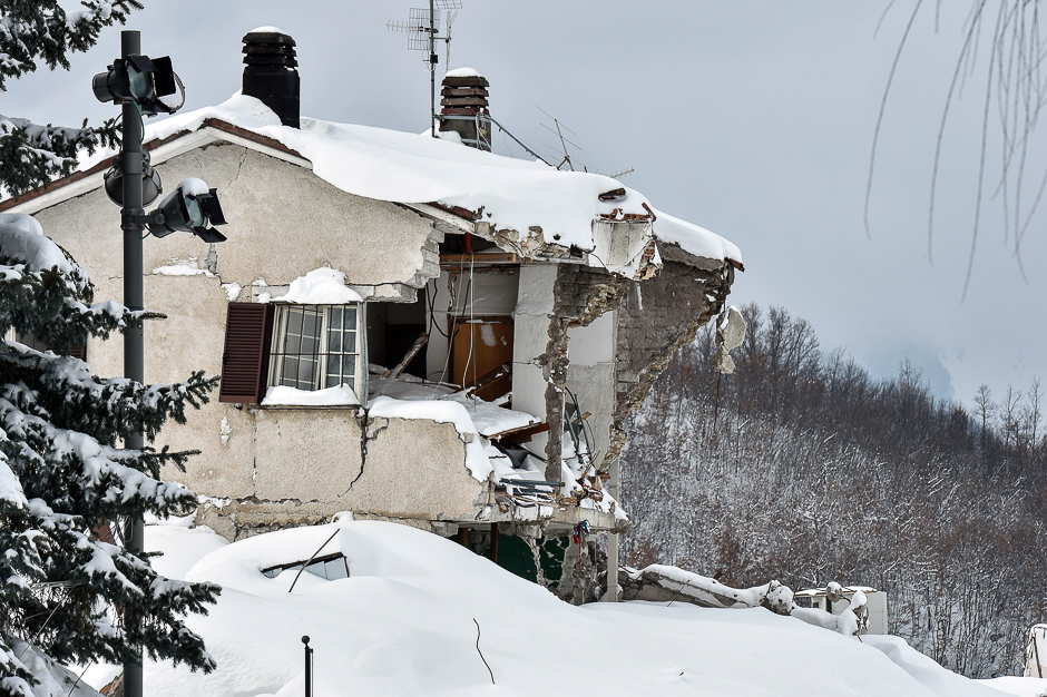 Rubble and debris of a destroyed building covered with snow are pictured in the damaged central Italian village of Amatrice, after a 5.7-magnitude earthquake struck the region. PHOTO: AFP