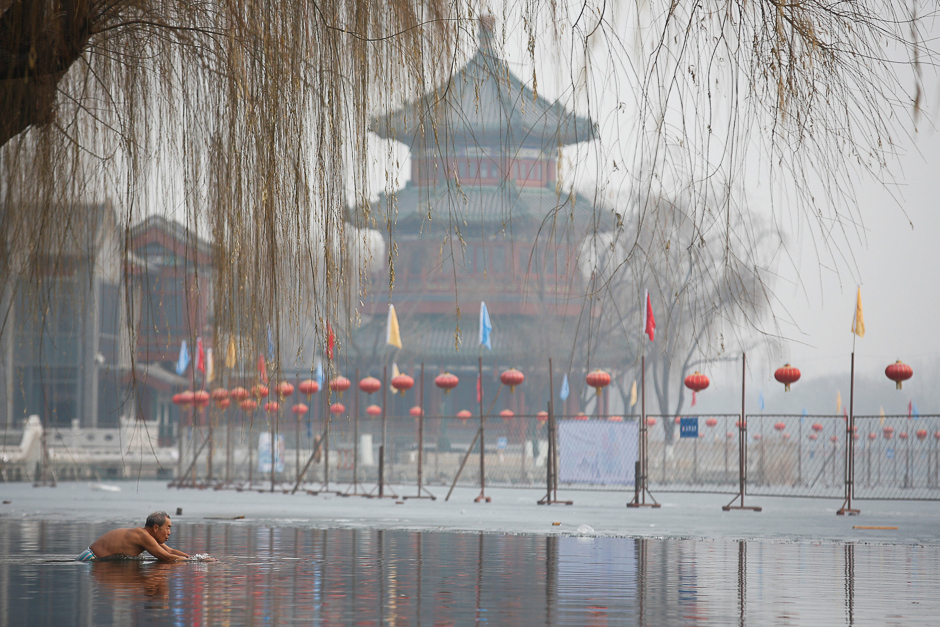 A man swims in the partially frozen Houhai lake in Beijing, China. PHOTO: REUTERS