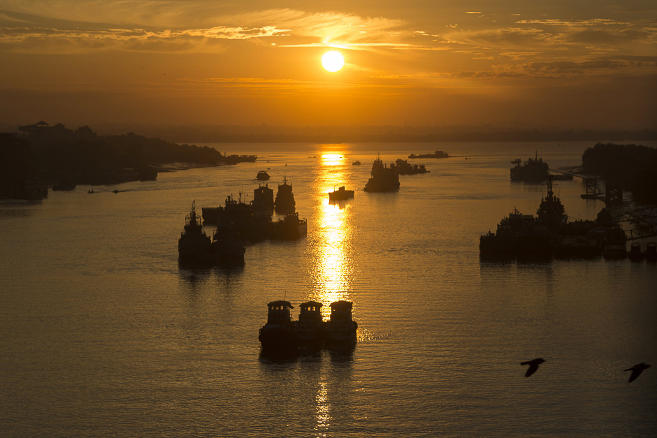 This photo shows boats on the Yangon river during sunrise in Yangon. PHOTO: AFP