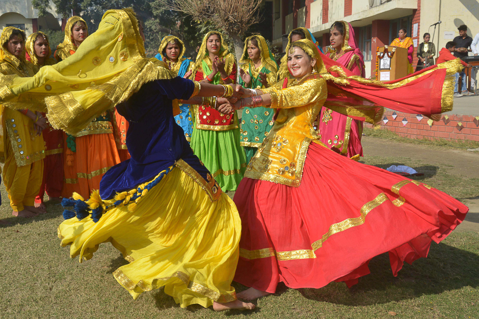 Young Indian students wear traditional Punjabi dress as they perform the 'Giddha' dance during celebrations on the occasion of the Lohri Festival in Amritsar. PHOTO: AFP