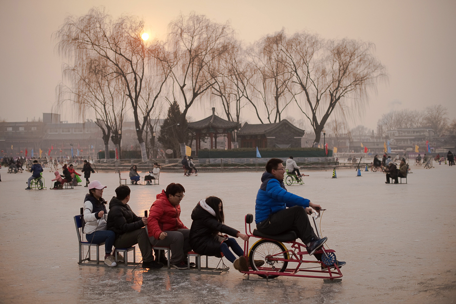 People enjoy riding on the ice of the Houhai frozen lake ahead of the Lunar New Year in Beijing. PHOTO: AFP