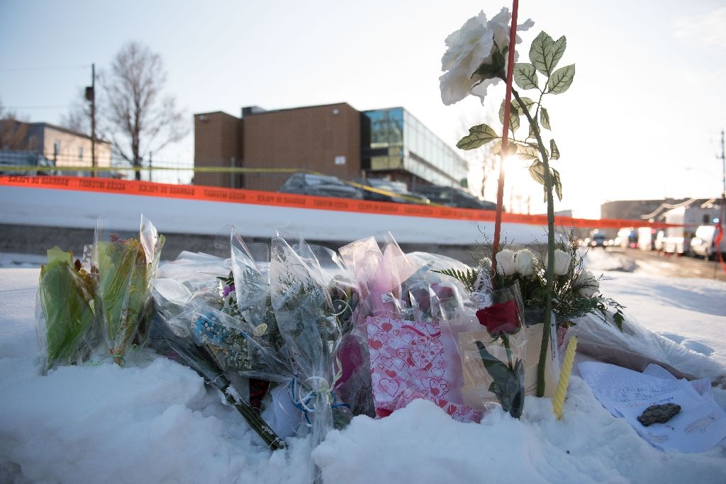 flowers at a makeshift memorial near the islamic cultural center in quebec city canada on january 30 2017 photo afp