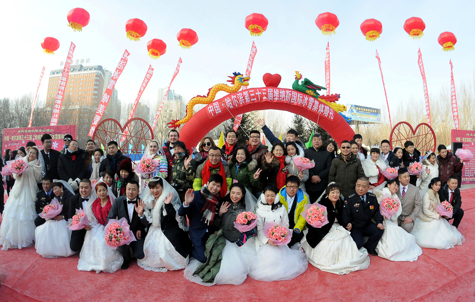 Couples pose for pictures during a mass wedding on the second day of Harbin's International Ice Festival, in Harbin, Heilongjiang province, China. PHOTO: REUTERS