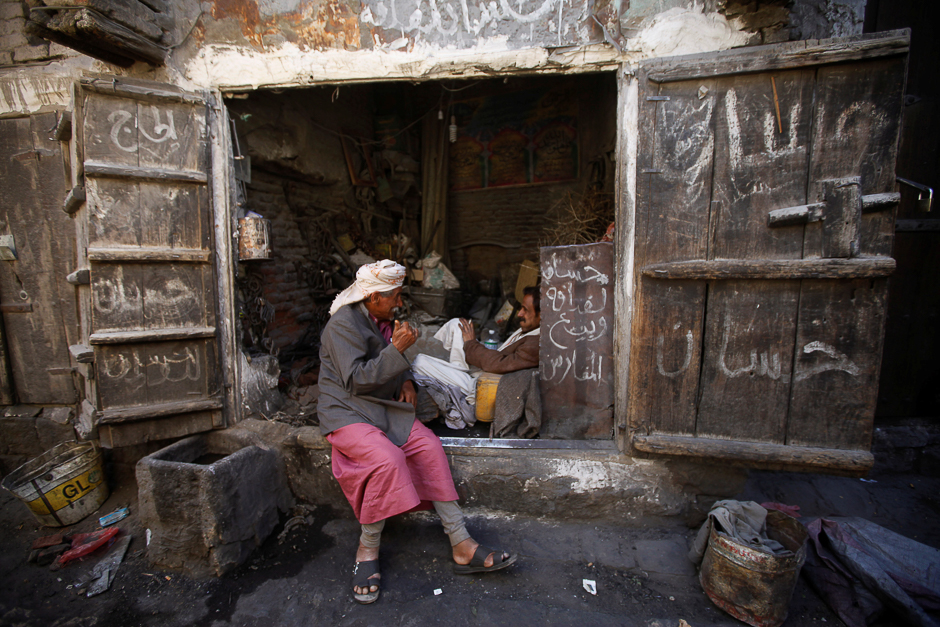 A man talks to another while sitting outside a shop at the old market in the historic city of Sanaa, Yemen. PHOTO: REUTERS