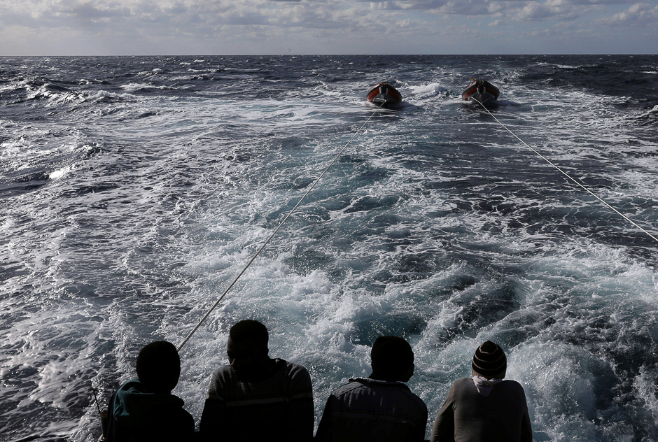 Migrants are seen at the stern of the former fishing trawler Golfo Azzurro, a day after they were rescued along with other migrants, including children and pregnant women, by the Spanish NGO Proactiva Open Arms after the raft they were on drifted out of control in the central Mediterranean Sea. PHOTO: REUTERS