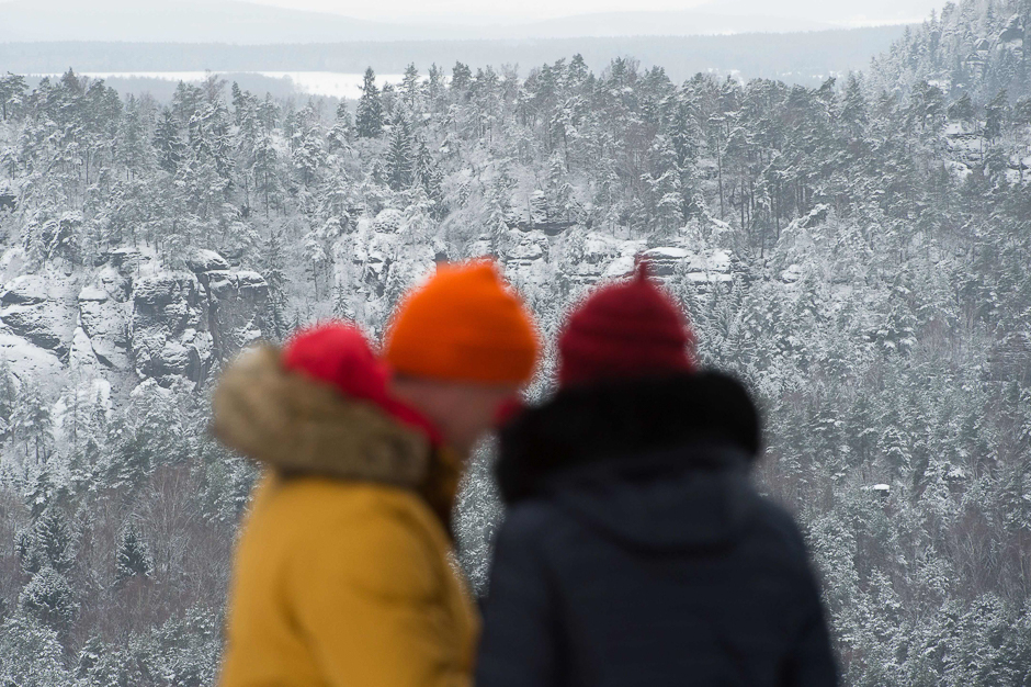 Tourists have a view from the Bastei rock massiv over the snowy landscape at the Nationalpark Saechsische Schweiz (National Park Region Saxon Switzerland) near Rathen, eastern Germany. PHOTO: AFP
