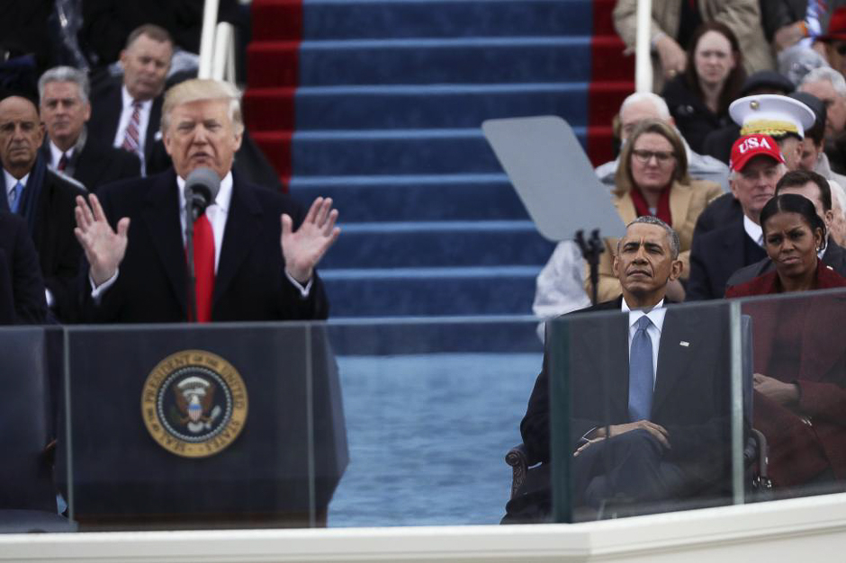 Former president Obama looks on as President Donald Trump speaks. PHOTO: REUTERS 