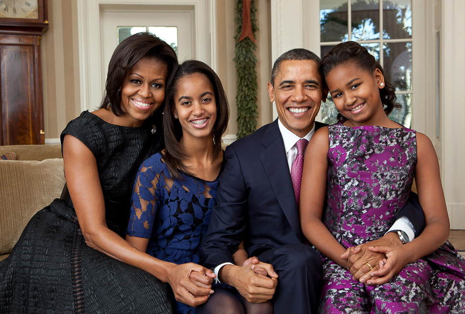 President Barack Obama, First Lady Michelle Obama, and their daughters, Sasha and Malia, sit for a family portrait in the Oval Office. PHOTO: PETE SOUZA