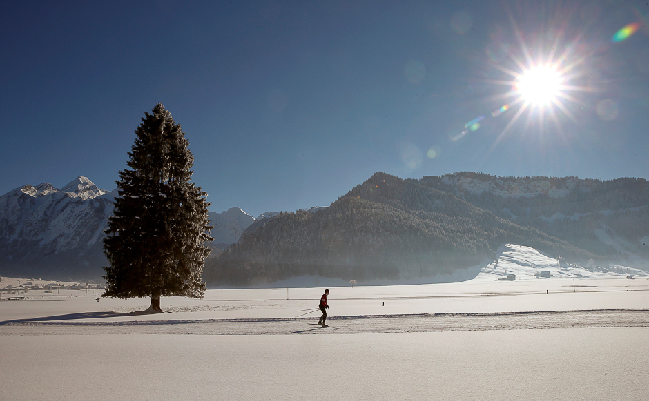 A cross-country skier is seen in the snow-covered landscape during sunny winter weather near Unteriberg, Switzerland. PHOTO: REUTERS