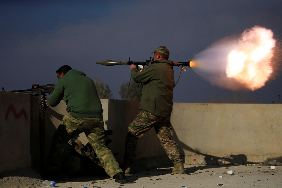 A member of Iraqi rapid response forces fires a rocket launcher during a battle with Islamic State militants in the district of Yarimja in southern Mosul. PHOTO: REUTERS
