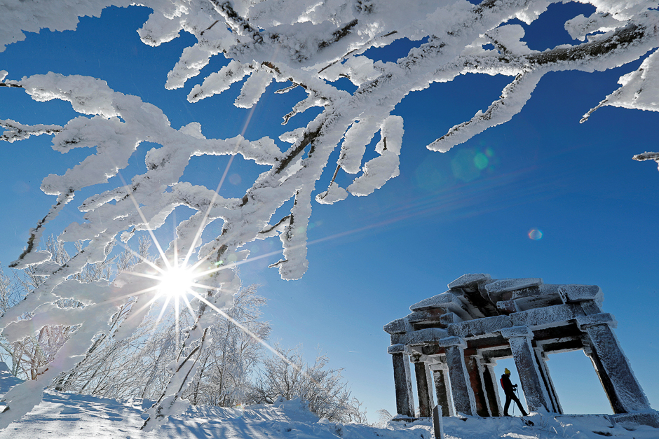 A hiker using snow-shoes visits the building that imitates a greco-roman temple which was built in 1869 on the summit of the Donon mountain as he enjoys a cold and sunny winter day in the Vosges mountains, in Granfontaine, near Strasbourg, France. PHOTO: REUTERS