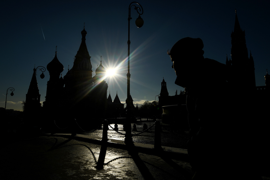A man walks across Red Square, with the Kremlin's Spasskaya (Saviour) Tower (R) and St. Basil's Cathedral seen in the background, in air temperatures of about minus 10 degrees Celsius in central Moscow. PHOTO: AFP