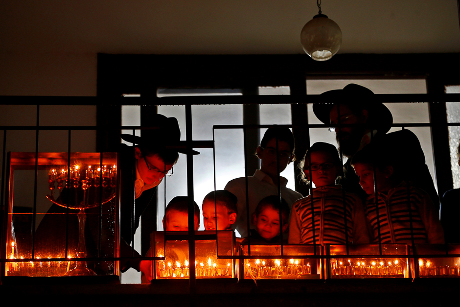 An ultra-Orthodox Jewish family lights candles in Bnei Brak, Israel. PHOTO: REUTERS