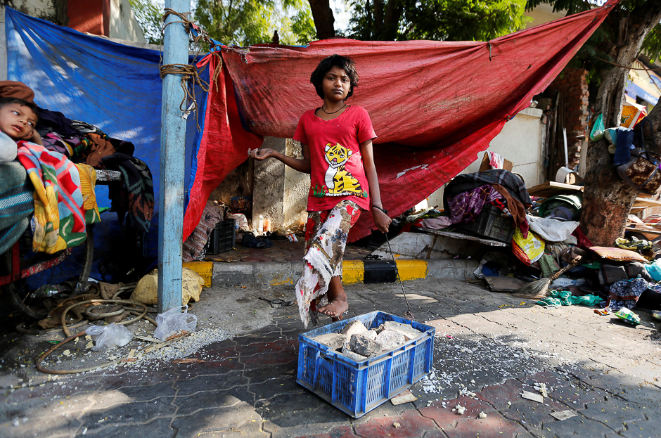 A mentally disabled girl named America Patni, 18, is tied to a plastic crate full of stones at her makeshift shelter on a roadside in Ahmedabad, India. PHOTO: REUTERS