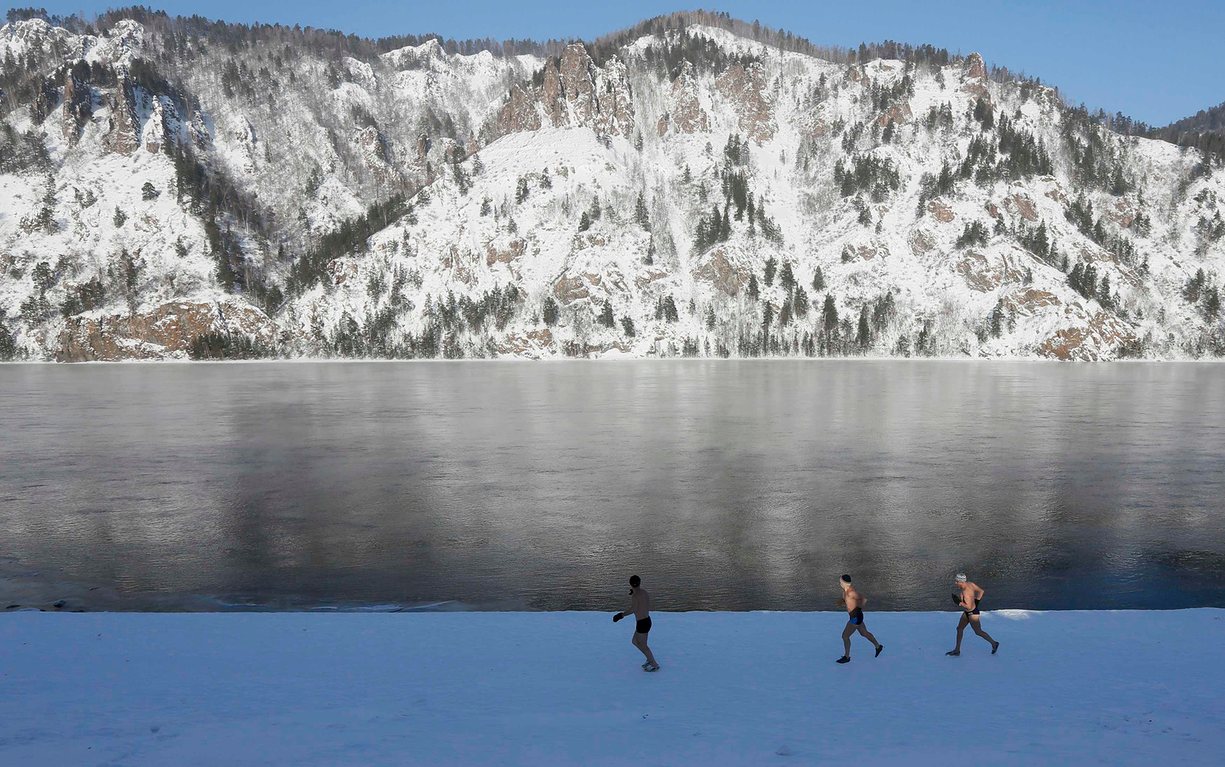 Enthusiasts of winter swimming warm up on the bank of the Yenisei river, with the air temperature at about minus 26C, Divnogorsk, Russia. PHOTO: REUTERS