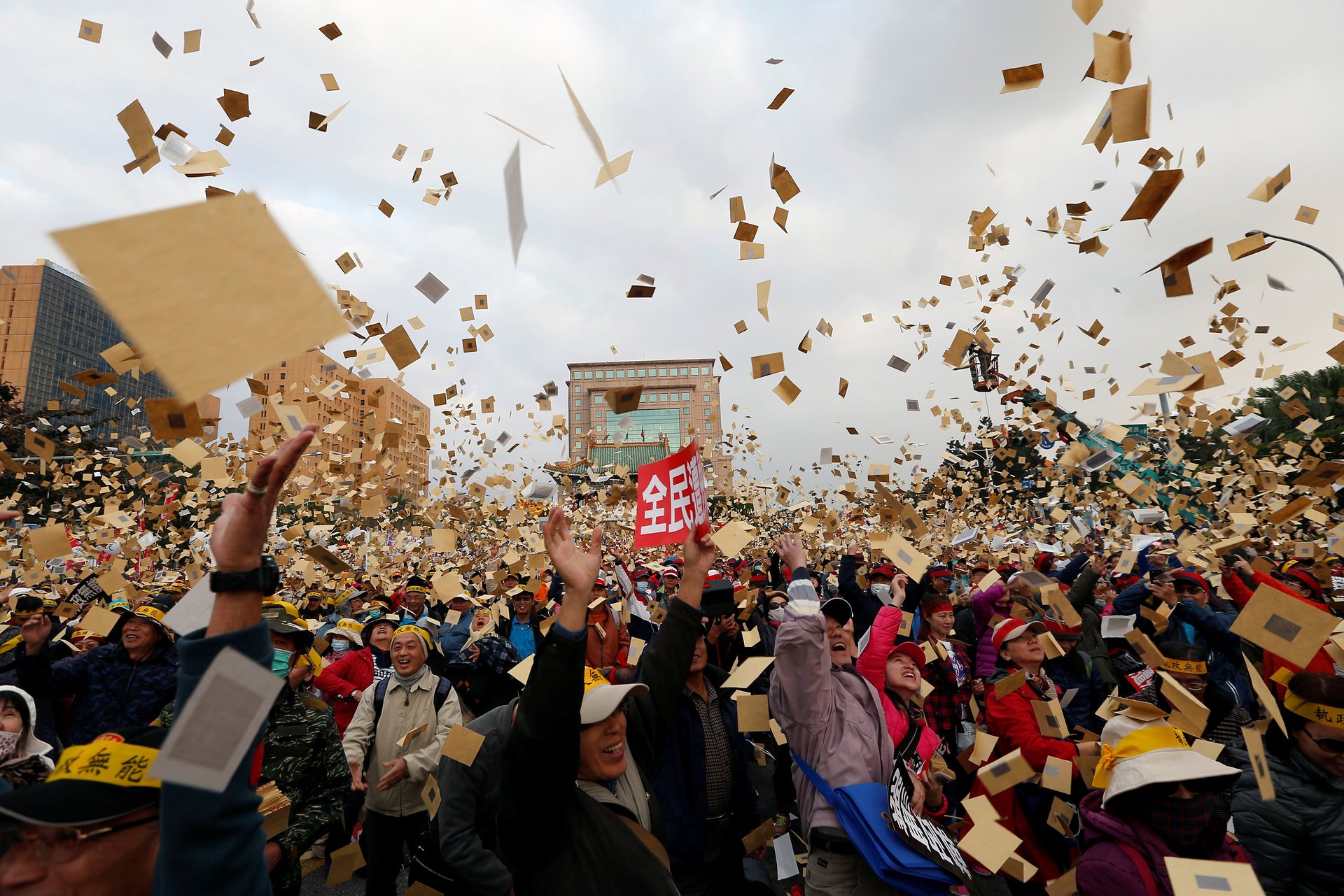 Protesters throw hell money, fake banknotes burnt at funerals, during a rally against the overhaul of the military and civil service pension fund. PHOTO: REUTERS