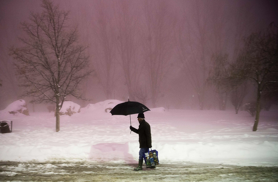 A man walks under snowfall in a street of Ifrane as a cold wave hits Morocco. PHOTO: AFP