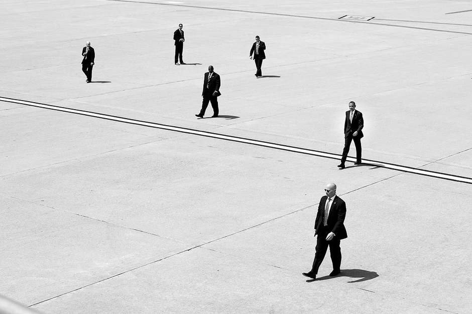 A beautifully composed, graphic shot of Obama and the secret service walking to Air Force One in Los Angeles. PHOTO: PETE SOUZA