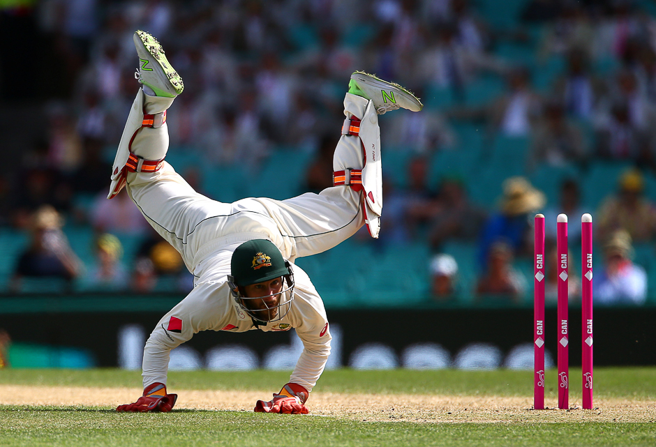 Australia's wicketkeeper Matthew Wade dives but fails to stop the ball thrown at the wicket by teammate Nathan Lyon. PHOTO: REUTERS