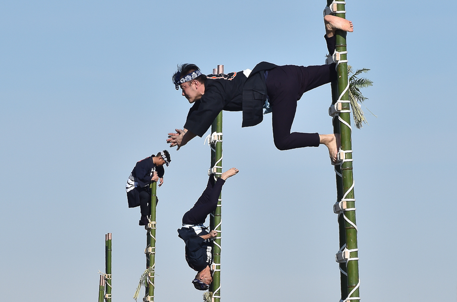 Members of the Edo Firemanship Preservation Association balance on top of bamboo ladders during a presentation at the Tokyo Fire Department's New Year fire review. PHOTO: AFP