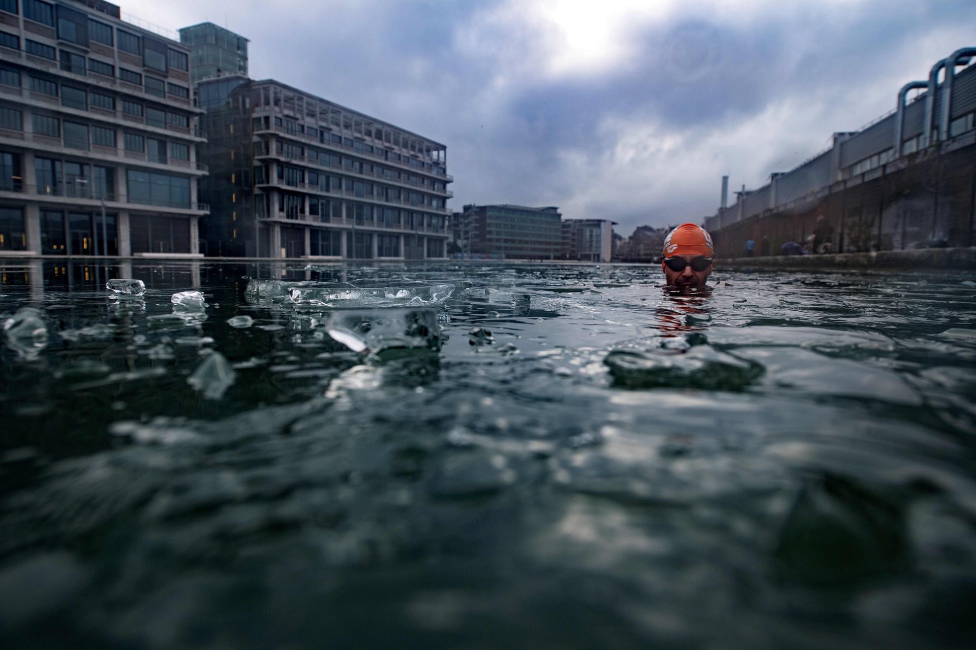 Swimming through the ice of the partly frozen Ourcq canal near Paris, Pantin, France. PHOTO: AFP