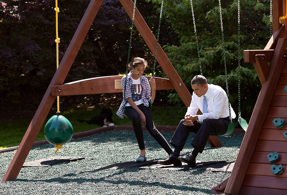 Obama talks with his daughter Malia on the swing set outside the Oval Office. PHOTO: PETE SOUZA 