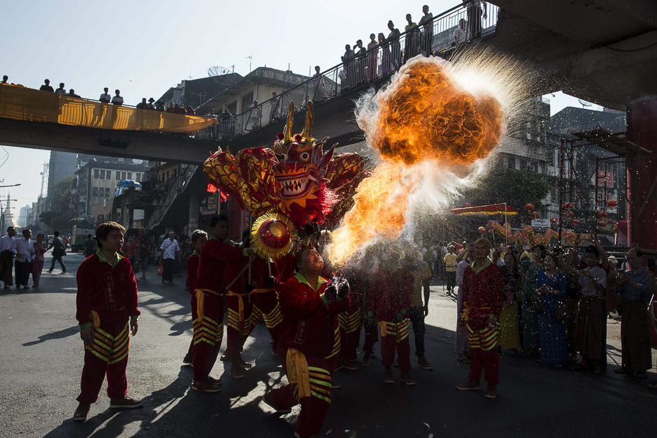 A group of people perform the traditional dragon and lion dance through the streets during the first day of the Lunar New Year in Yangon's Chinatown district. PHOTO: AFP