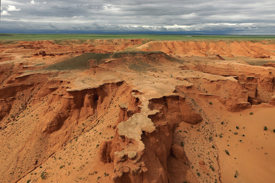 This aerial picture shows two tourists on the Flaming Cliffs in the Gobi desert. PHOTO: AFP