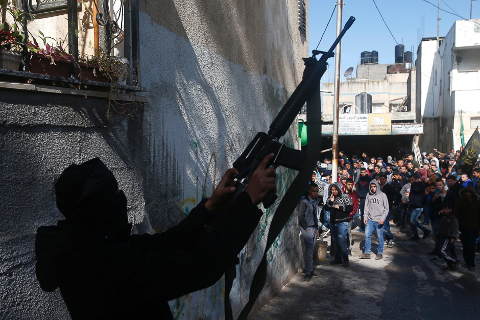 A Palestinian gunman flashes his weapon during the funeral of Mohammed Abu Khalifa, who was shot dead by Israeli forces, in the Jenin refugee camp, near the West Bank city of Jenin. PHOTO: AFP