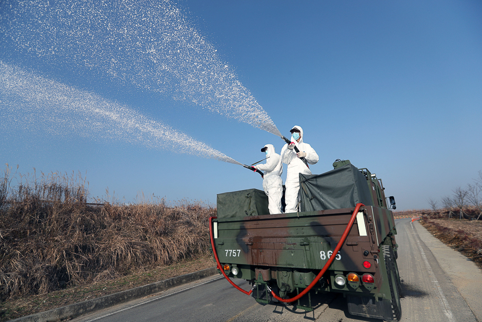 South Korean navy soldiers disinfect in Changwon, South Korea. PHOTO: REUTERS