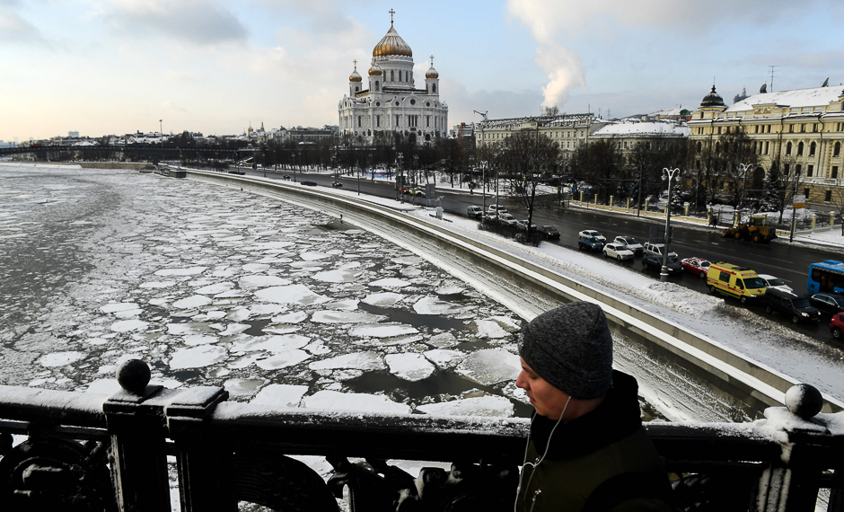 A man walks along a bridge over the ice-covered Moskva River, with the Christ the Saviour Cathedral seen in the background, in Moscow. PHOTO: AFP