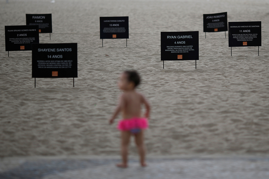 Signs that bear the names of children killed by stray bullets are seen during a protest calling for an end to the violence that erupts during police operations against suspected drug traffickers and thieves, at the Copacabana beach in Rio de Janeiro, Brazil. PHOTO: REUTERS