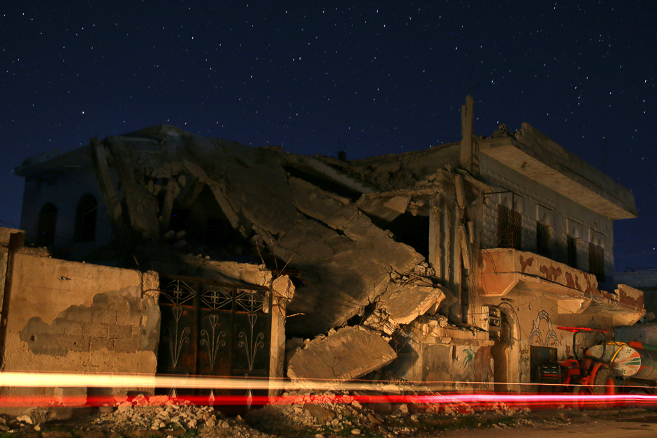 Damaged buildings are pictured at night in the rebel-held town of Dael, in Deraa Governorate, Syria. PHOTO: REUTERS