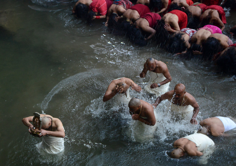 Nepalese Hindu devotees gather to bathe in the Shali River on the outskirts of Kathmandu. Hundreds of married and unmarried women in the Himalayan nation have started a month-long fast in the hope of a prosperous life and conjugal happiness. PHOTO: AFP