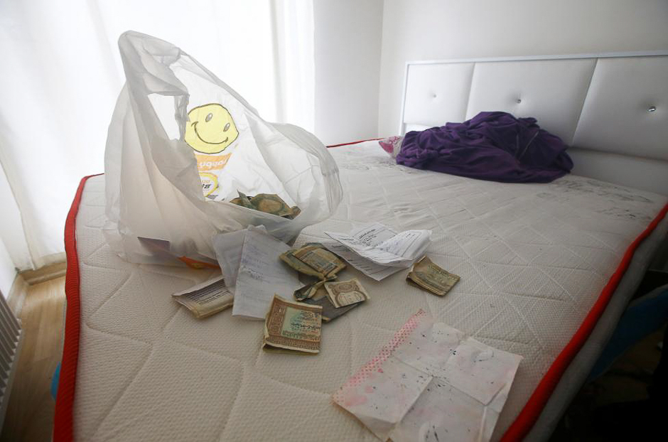 Foreign currency banknotes and various documents are seen in the bedroom of a hideout where the alleged attacker of Reina nightclub was caught. PHOTO: REUTERS